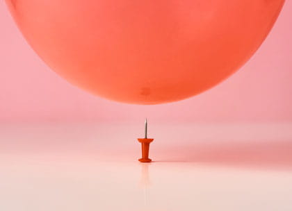 Balloon floating above a pin